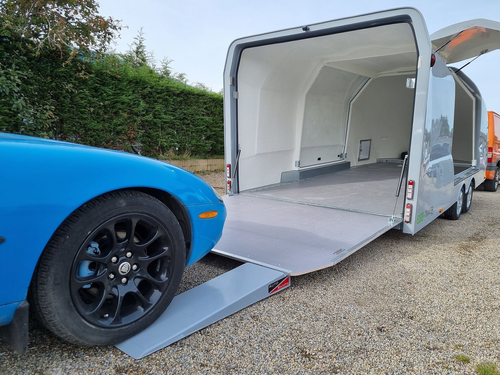 Classic car loaded into an enclosed transport trailer